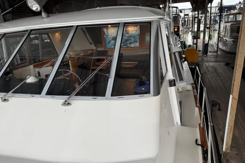 Slide: The Image of Interior of 1985 Bayliner 4550 Motoryacht with helm controls and white seating. - 105