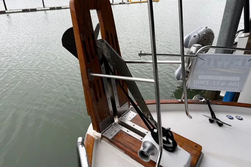 Slide: The Image of 1985 Bayliner 4550 Motoryacht deck with hatches and fenders, docked by the water. - 110