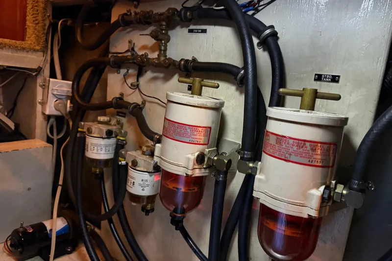 Slide: The Image of 1985 Bayliner 4550 Motoryacht anchor system on deck by the water. - 112