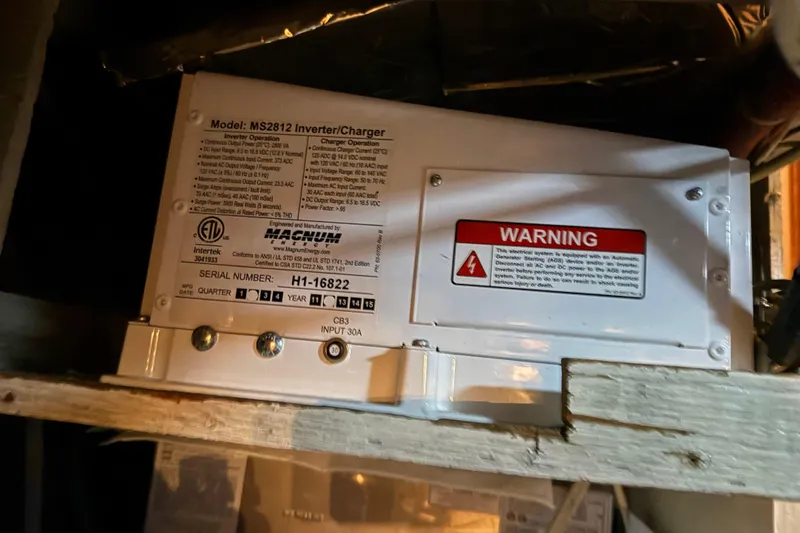 Slide: The Image of Engine room of 1985 Bayliner 4550 Motoryacht with fire extinguisher and equipment. - 115