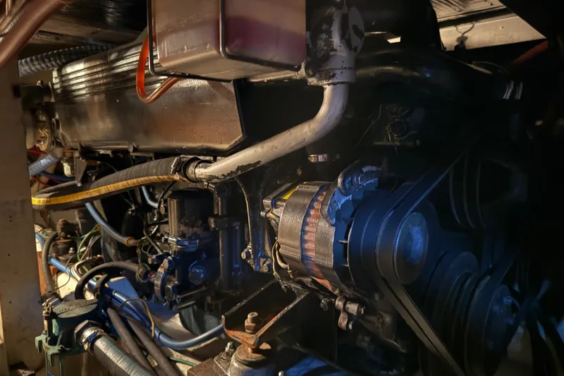 Slide: The Image of Engine room of a 1985 Bayliner 4550 Motoryacht, showcasing mechanical components and wiring. - 118