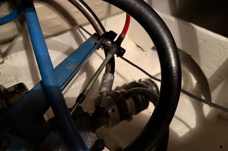 Slide: The Image of Engine room of 1985 Bayliner 4550 Motoryacht, showcasing mechanical components and wiring. - 121