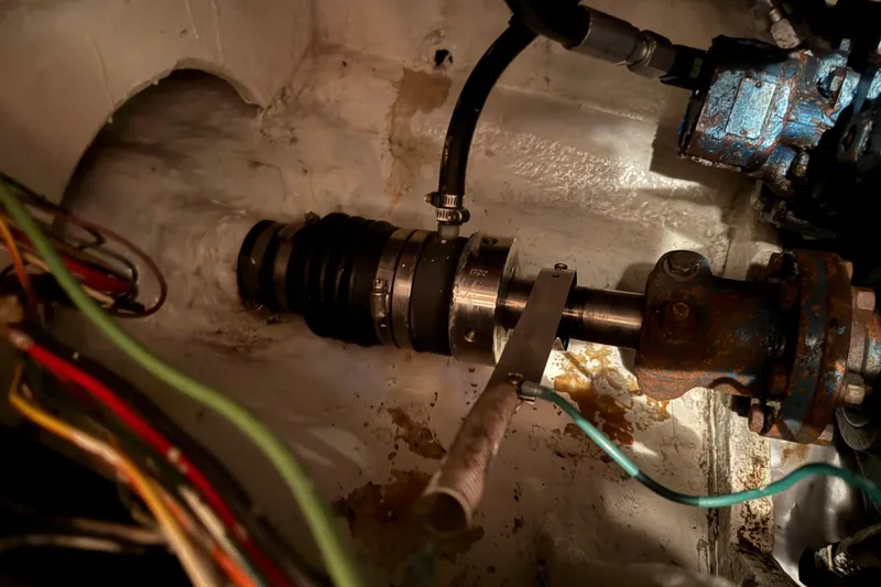 Slide: The Image of Engine room of 1985 Bayliner 4550 Motoryacht showing pipes and electrical components. - 122