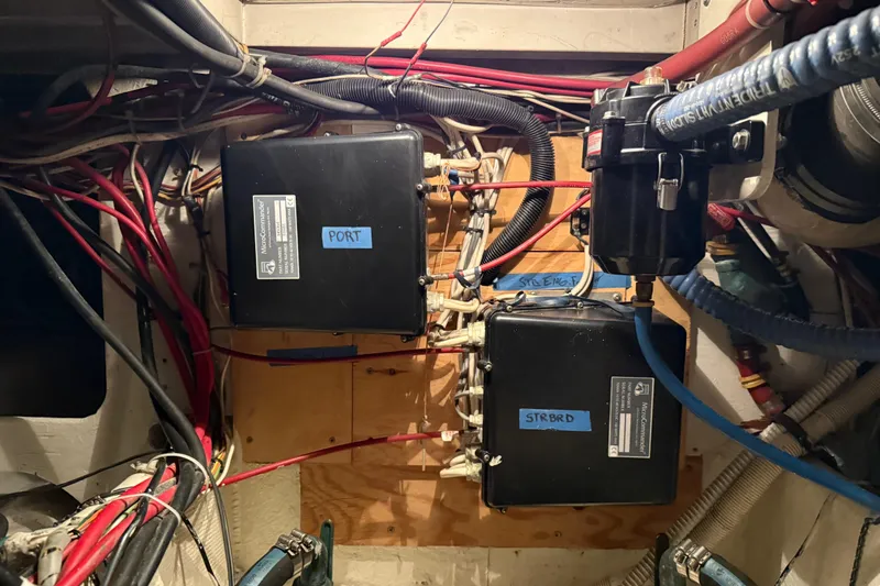 Slide: The Image of Engine compartment of 1985 Bayliner 4550 Motoryacht showing steering mechanism and cables. - 123