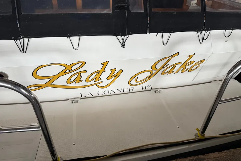 Slide: The Image of 1985 Bayliner 4550 Motoryacht with clear enclosure, docked at marina. - 128