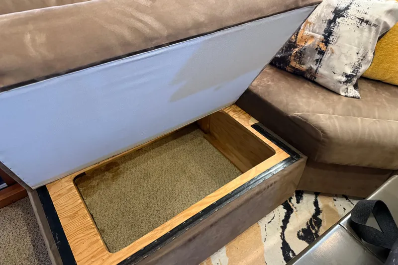 Slide: The Image of Luxurious interior of 1985 Bayliner 4550 Motoryacht with plush seating and decorative pillows. - 13