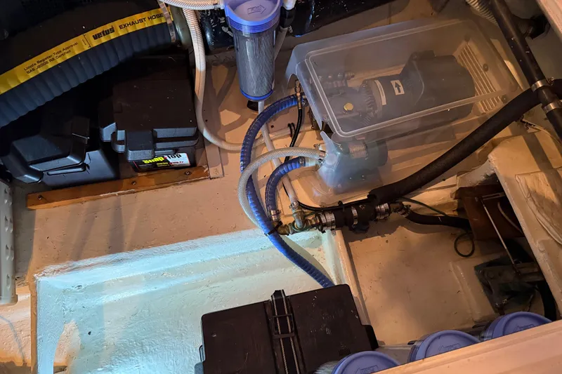 Slide: The Image of Engine compartment of a 1985 Bayliner 4550 Motoryacht showing mechanical components and hoses. - 133