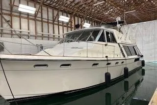 Slide: The Image of Stainless steel grill on 1985 Bayliner 4550 Motoryacht, with coiled ropes and wooden trim. - 145