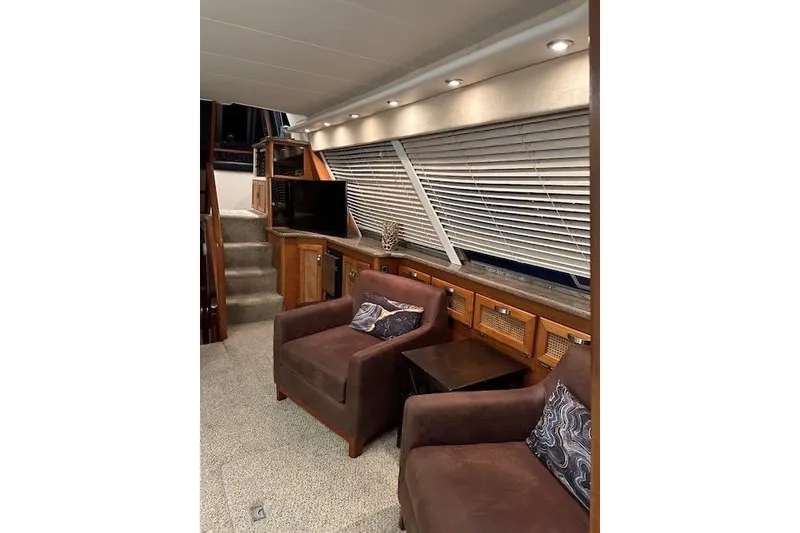 Slide: The Image of Open storage compartment in 1985 Bayliner 4550 Motoryacht interior, with cushions and decorative pillows. - 15