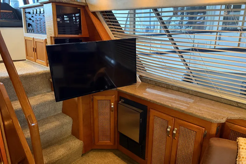 Slide: The Image of Interior of 1985 Bayliner 4550 Motoryacht with TV, cabinets, and carpeted stairs. - 18