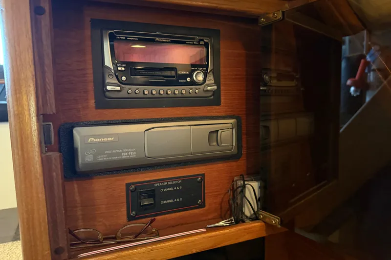 Slide: The Image of 1985 Bayliner 4550 Motoryacht interior with TV, wooden cabinetry, and carpeted stairs. - 19