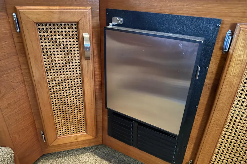 Slide: The Image of Interior of 1985 Bayliner 4550 Motoryacht with TV, stairs, and wooden cabinetry. - 20