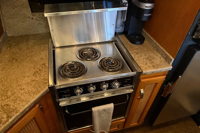 Slide: The Image of Interior of 1985 Bayliner 4550 Motoryacht with open storage compartment and lamp. - 31