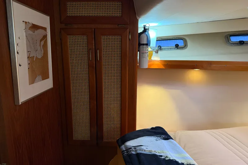 Slide: The Image of 1985 Bayliner 4550 Motoryacht interior hallway with wooden doors and carpeted floor. - 41