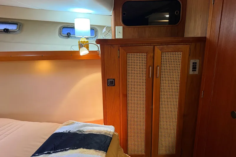Slide: The Image of Interior of 1985 Bayliner 4550 Motoryacht cabin with wooden closet and wall art. - 43