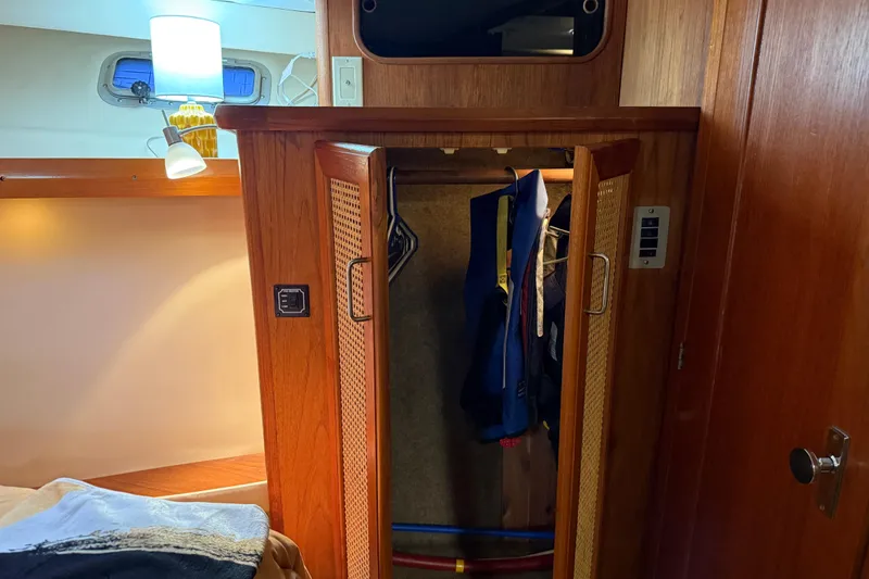Slide: The Image of Interior of 1985 Bayliner 4550 Motoryacht with bookshelf, artwork, and fire extinguisher. - 44
