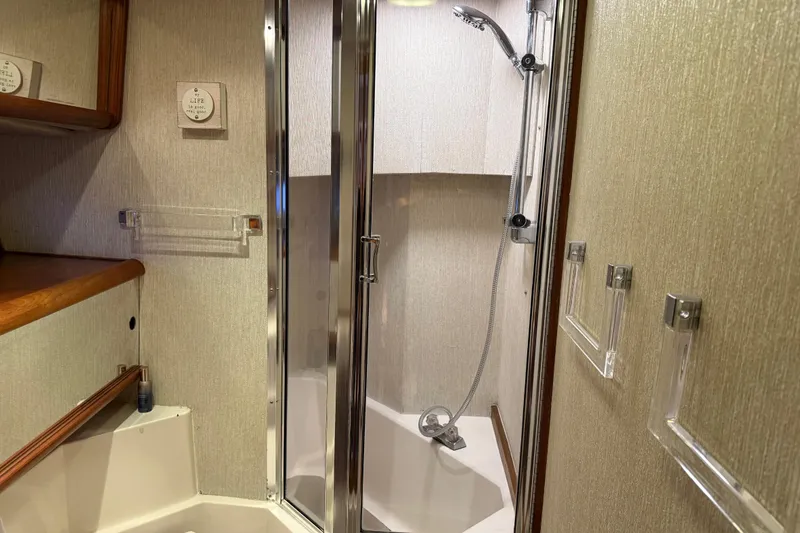 Slide: The Image of Bathroom interior of 1985 Bayliner 4550 Motoryacht with shower and wooden accents. - 48