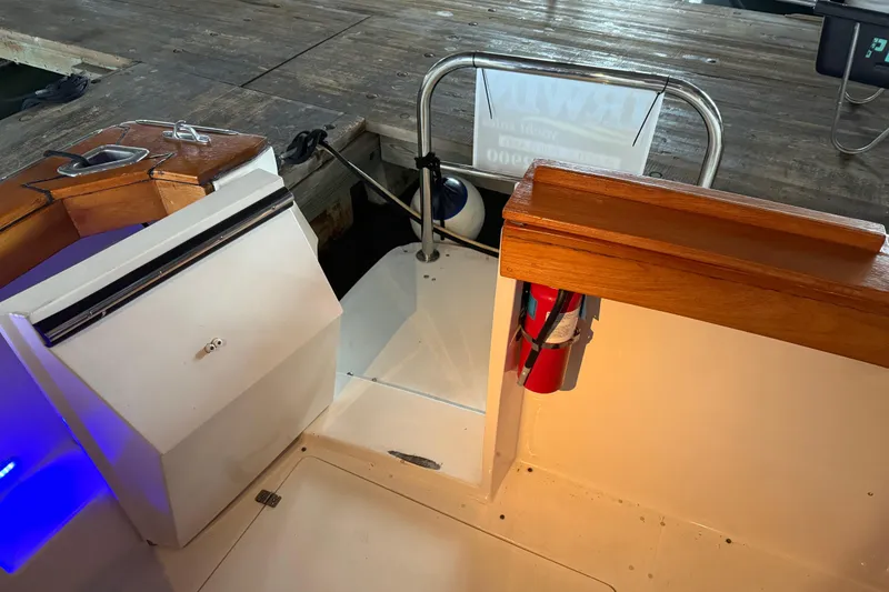 Slide: The Image of 1985 Bayliner 4550 Motoryacht docked in a covered marina, with interior lights on. - 5