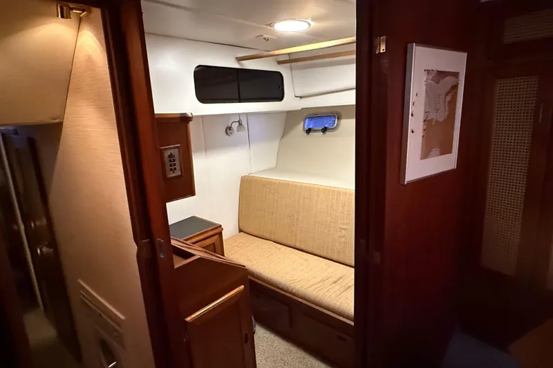 Slide: The Image of Interior of 1985 Bayliner 4550 Motoryacht bathroom with wooden shelves and porthole window. - 51