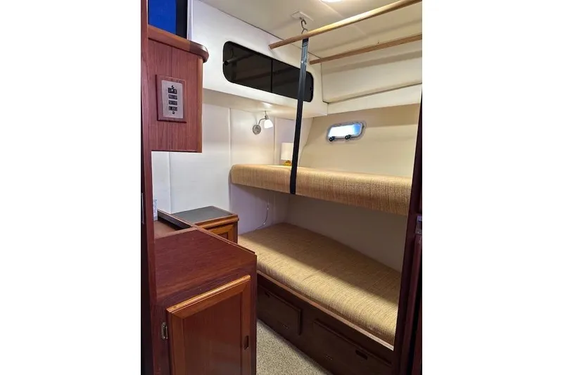 Slide: The Image of Wooden interior of 1985 Bayliner 4550 Motoryacht with books and storage compartment. - 55
