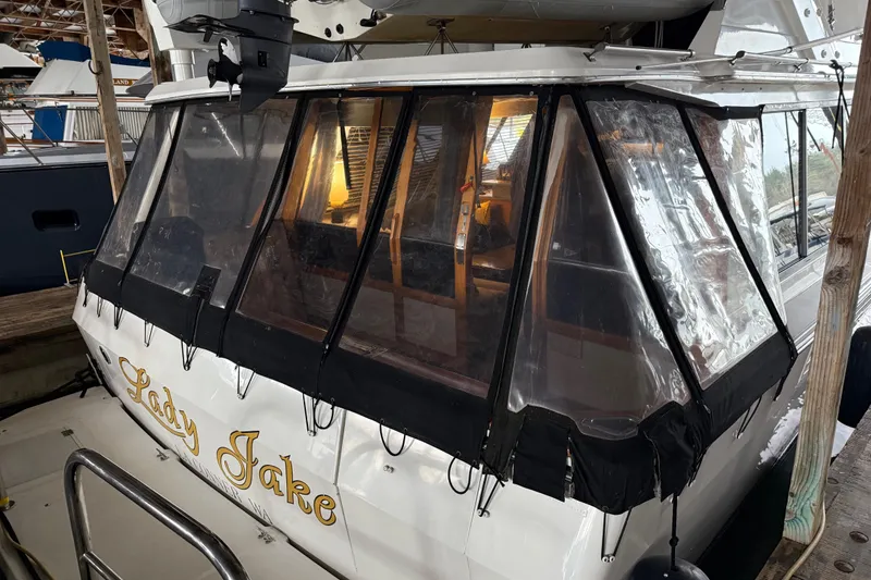 Slide: The Image of 1985 Bayliner 4550 Motoryacht interior with wooden trim and fire extinguisher. - 6