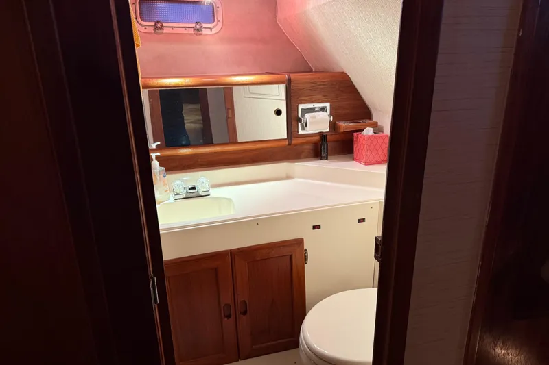 Slide: The Image of Storage compartment in 1985 Bayliner 4550 Motoryacht, filled with bags and life jackets. - 64