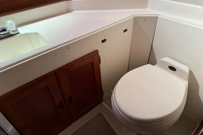 Slide: The Image of Cozy bedroom interior of 1985 Bayliner 4550 Motoryacht with wooden cabinet and stylish bedding. - 65