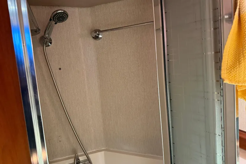 Slide: The Image of Bathroom interior of 1985 Bayliner 4550 Motoryacht with wooden cabinets and mirror. - 66