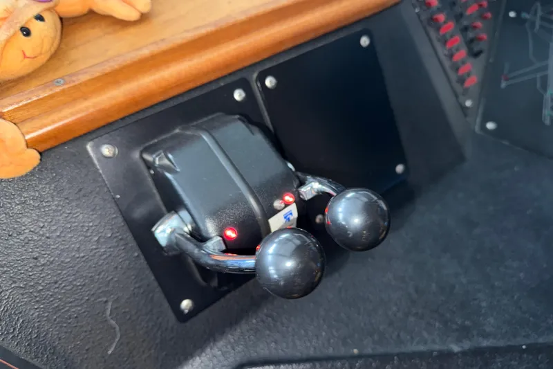 Slide: The Image of Control panel of a 1985 Bayliner 4550 Motoryacht with plush crab decoration. - 77