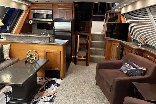 Slide: The Image of 1985 Bayliner 4550 Motoryacht docked, featuring enclosed cabin and visible name "Lady Jake." - 8