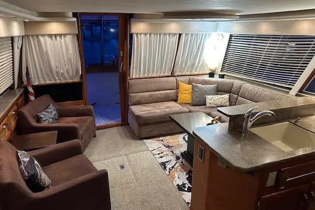 Slide: The Image of 1985 Bayliner 4550 Motoryacht with clear protective cover at dock. - 9