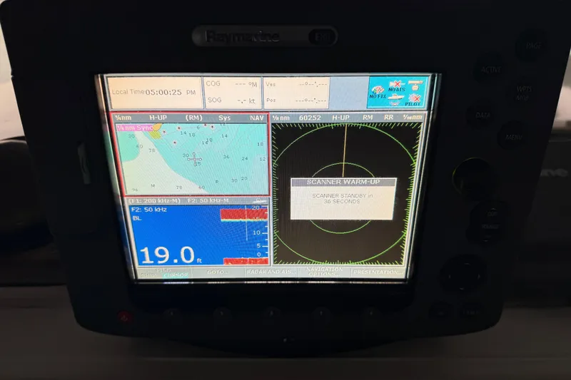 Slide: The Image of 1985 Bayliner 4550 Motoryacht helm with steering wheel, gauges, and navigation equipment. - 91