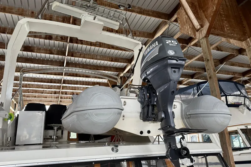 Slide: The Image of 1985 Bayliner 4550 Motoryacht with inflatable dinghy and outboard motor in marina. - 98