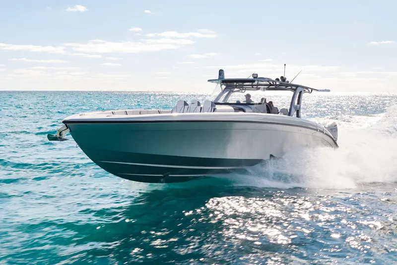 Slide: The Image of Midnight Express 43' Solstice boat cruising on clear blue ocean waters. - 1