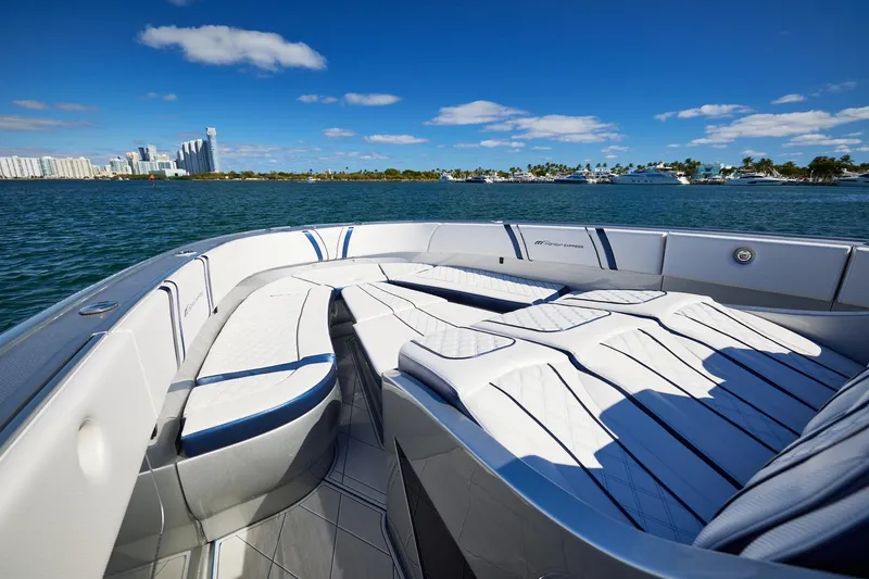 Slide: The Image of Luxury Midnight Express 43' Solstice boat with spacious seating, cruising near a city skyline. - 10