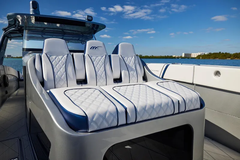 Slide: The Image of Luxurious seating on Midnight Express 43' Solstice boat, featuring elegant white and blue upholstery. - 12