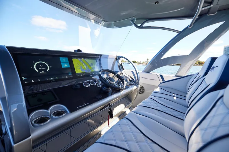 Slide: The Image of Interior of Midnight Express 43' Solstice boat with modern dashboard and luxurious seating. - 16