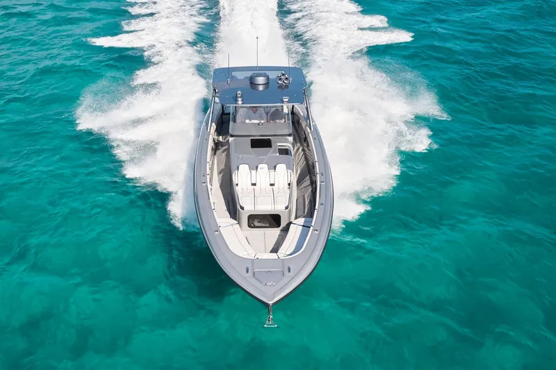 Slide: The Image of Midnight Express 43' Solstice boat cruising on clear turquoise water. - 2