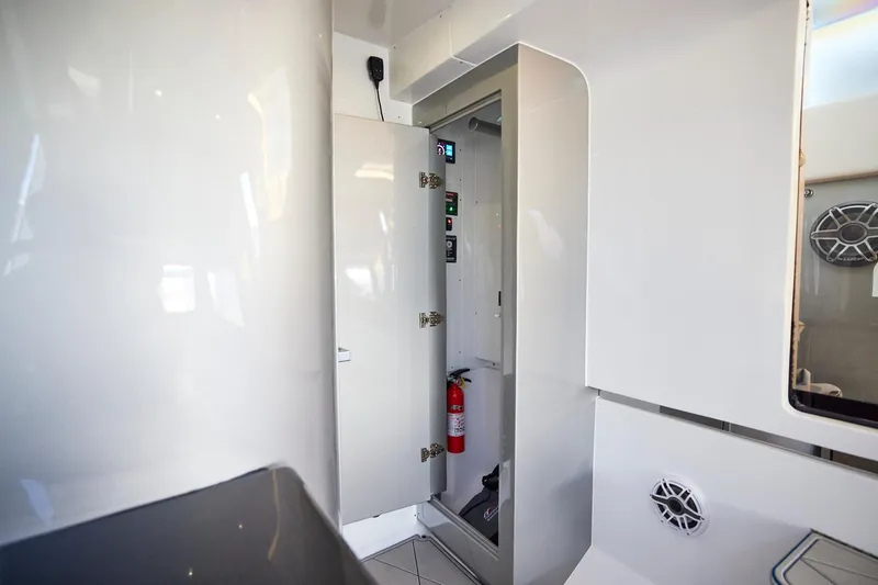 Slide: The Image of Interior of Midnight Express 43' Solstice boat, featuring sleek white cabinetry and safety equipment. - 21