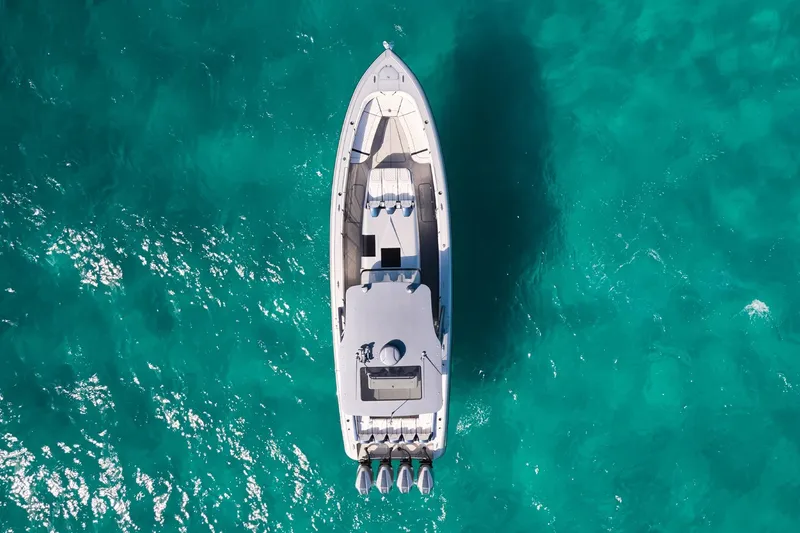 Slide: The Image of Aerial view of Midnight Express 43' Solstice boat on turquoise water. - 4