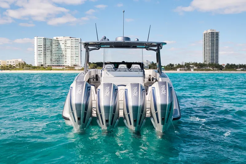 Slide: The Image of Midnight Express 43' Solstice boat with four engines on turquoise water, cityscape background. - 7