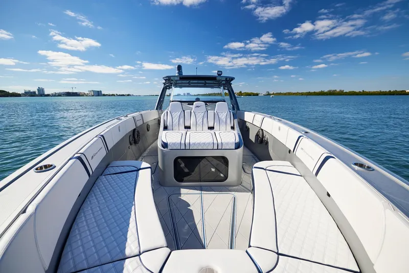 Slide: The Image of Luxury Midnight Express 43' Solstice boat interior on calm water under blue sky. - 8