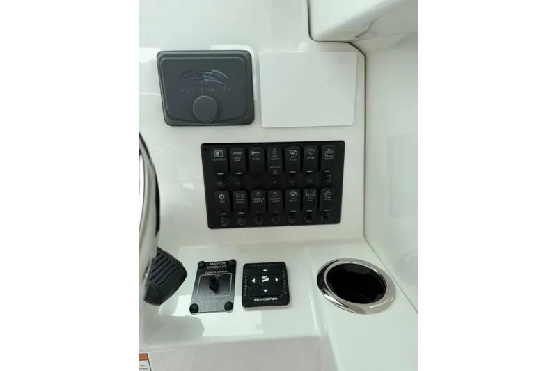 Slide: The Image of Control panel of 2026 Parker 227 Explorer boat with switches and cup holder. - 10