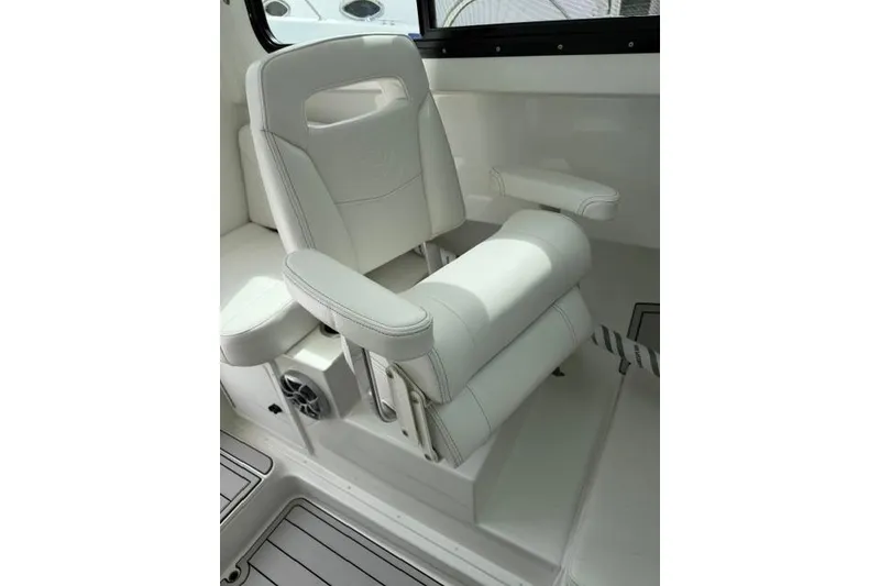 Slide: The Image of Luxury seating in 2026 Parker 227 Explorer boat, featuring white upholstery and armrests. - 13