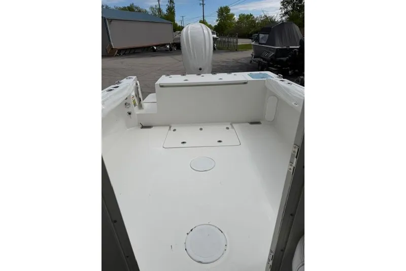Slide: The Image of 2026 Parker 227 Explorer boat deck, spacious and clean, with visible storage compartments. - 15