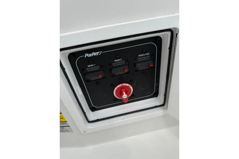 Slide: The Image of Control panel of 2026 Parker 227 Explorer boat with switches and red dial. - 21