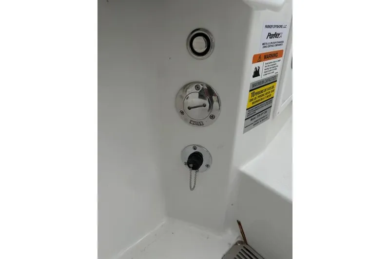 Slide: The Image of 2026 Parker 227 Explorer boat water inlet and warning labels. - 22