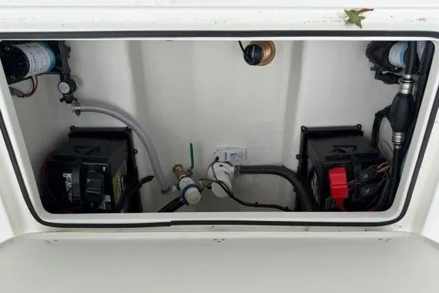 Slide: The Image of Battery compartment of 2026 Parker 227 Explorer boat, featuring dual batteries and wiring. - 23