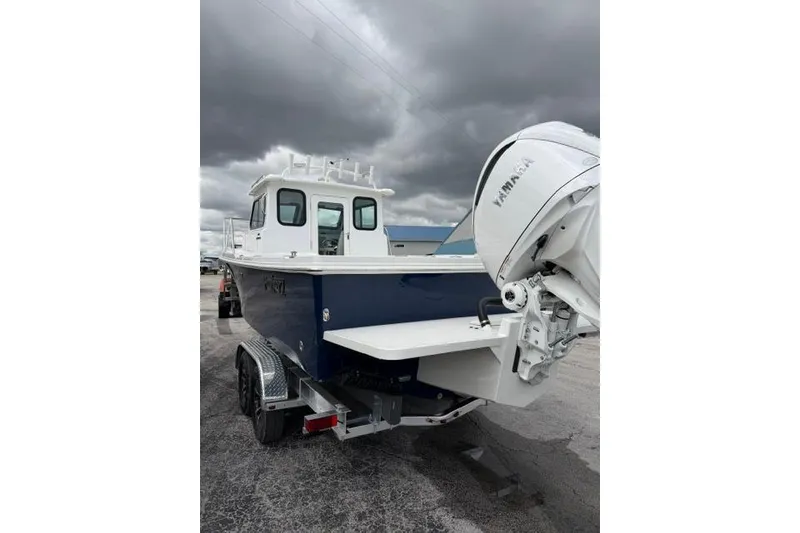 Slide: The Image of 2026 Parker 227 Explorer boat with Yamaha engine on trailer under cloudy sky. - 25