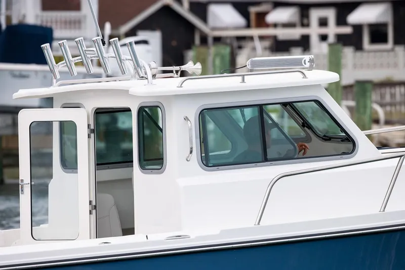 Slide: The Image of Manufacturer Provided Image: 2026 Parker 227 Explorer boat with sleek cabin design and rod holders. - 4